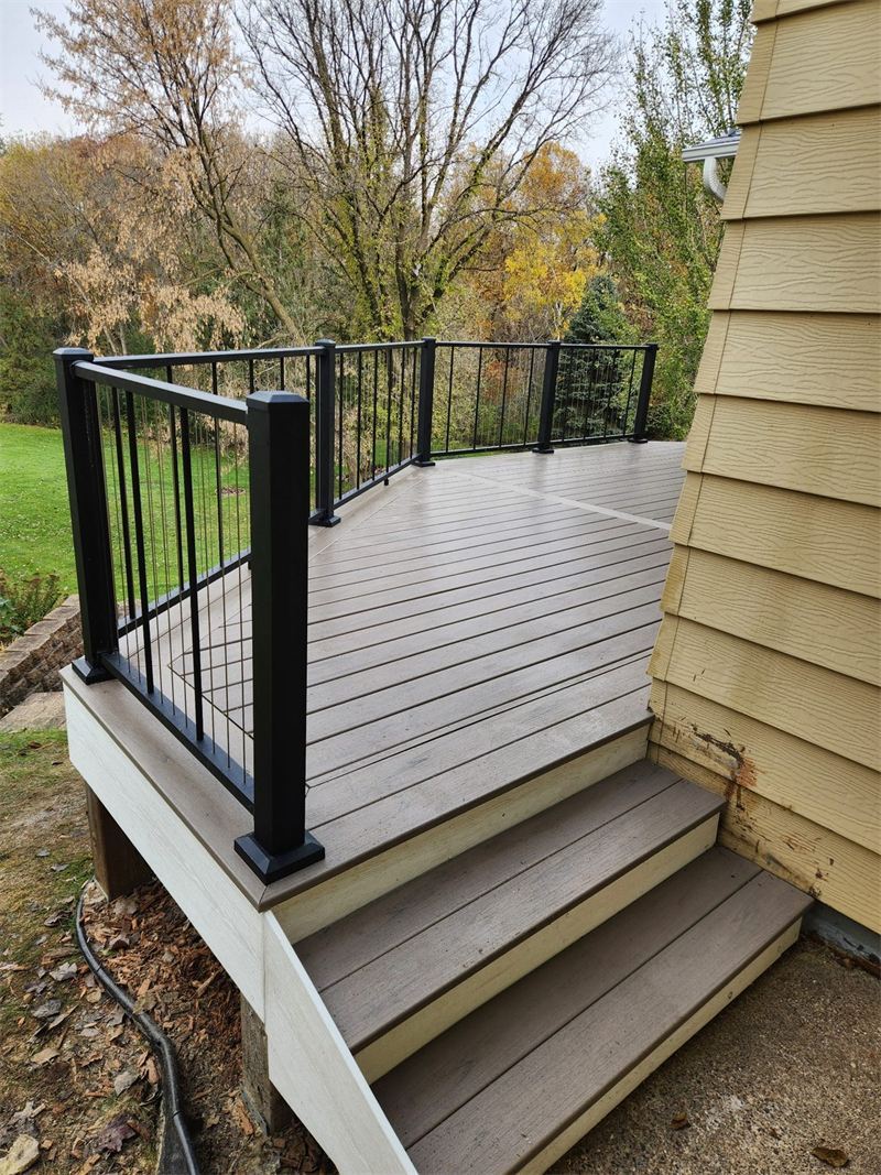 Composite deck with black aluminum railing, by New West Co