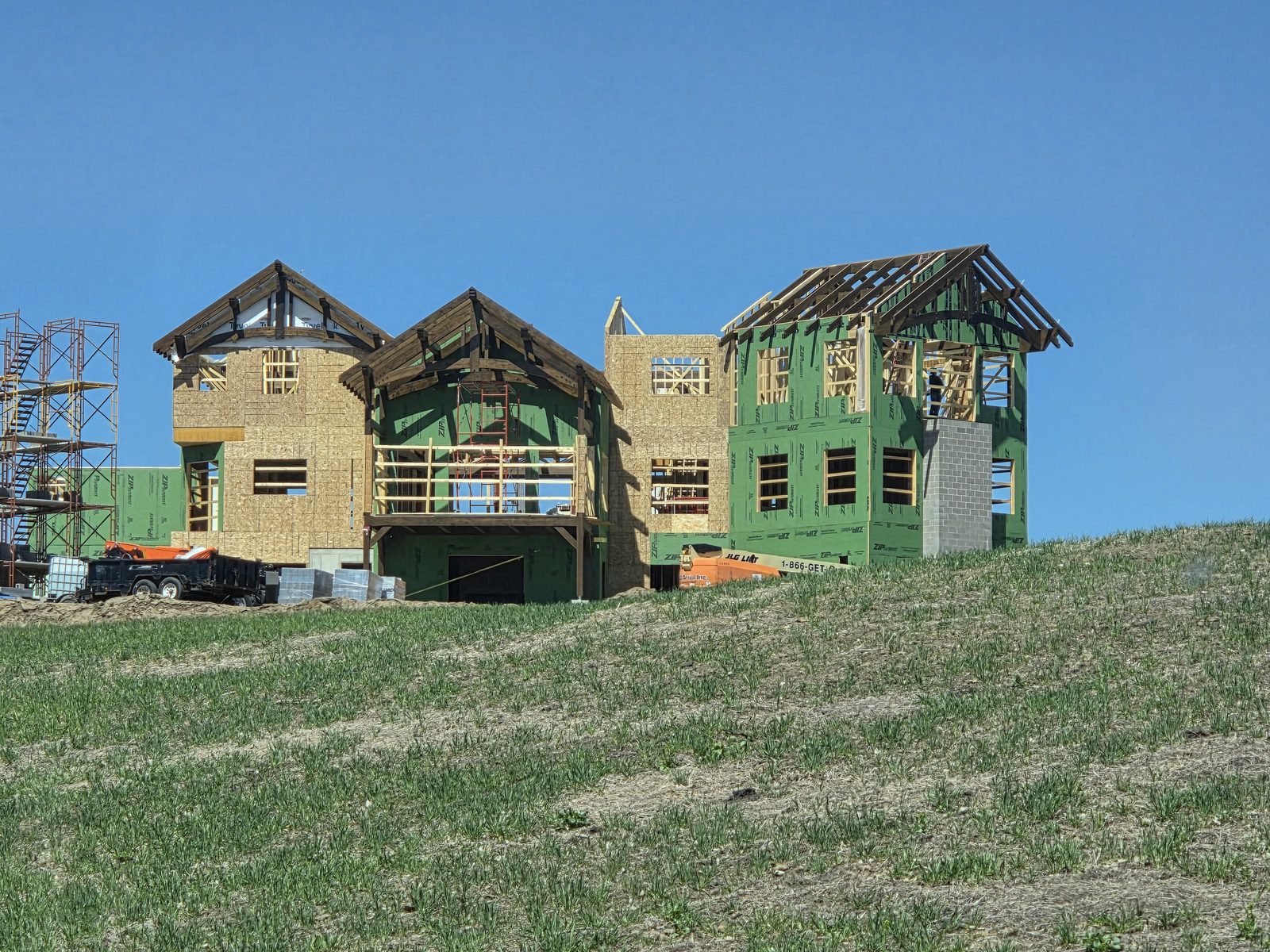 Custom home framing on a hill, built by New West Co
