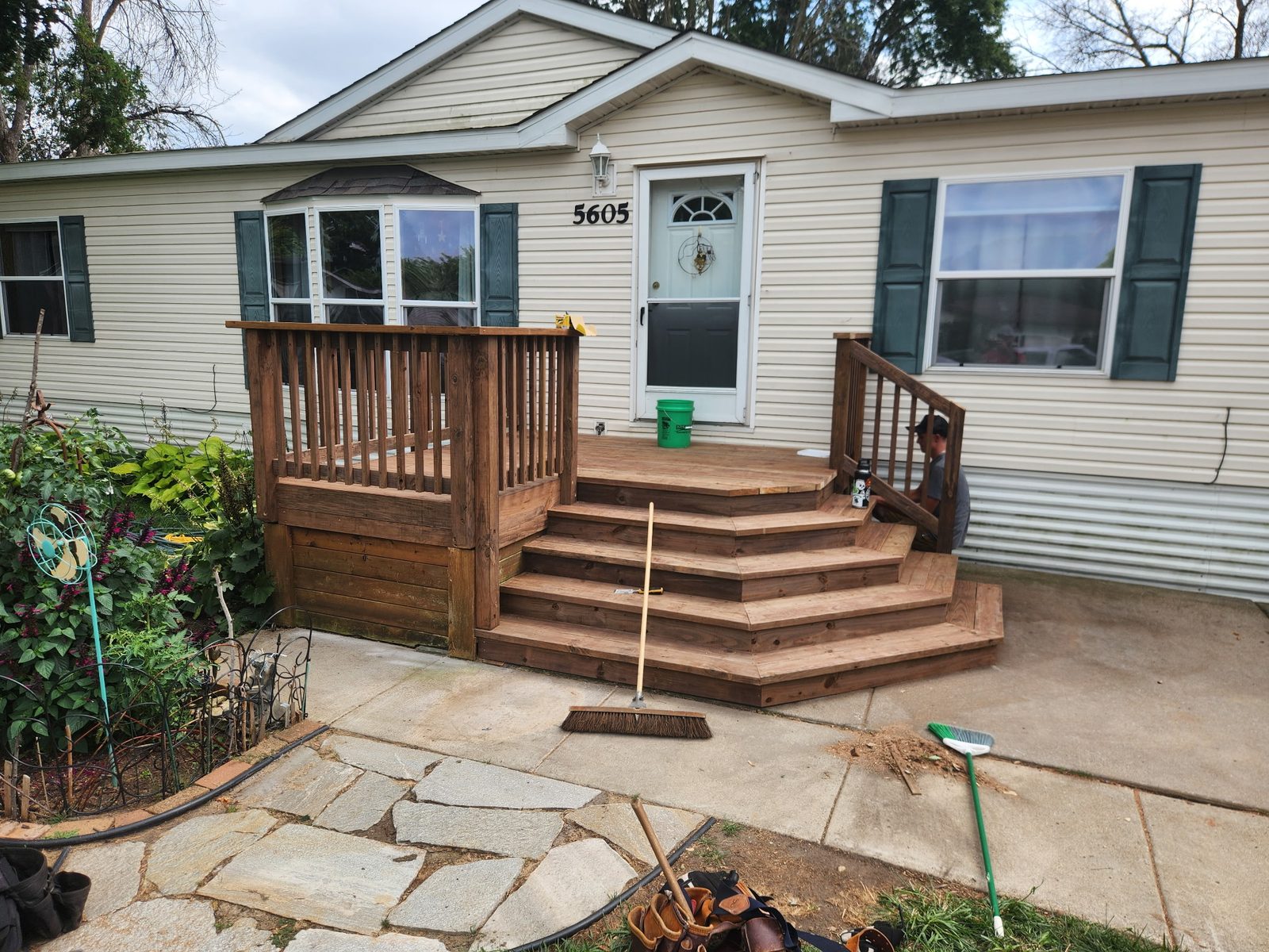 Wraparound cedar steps on a front entry deck