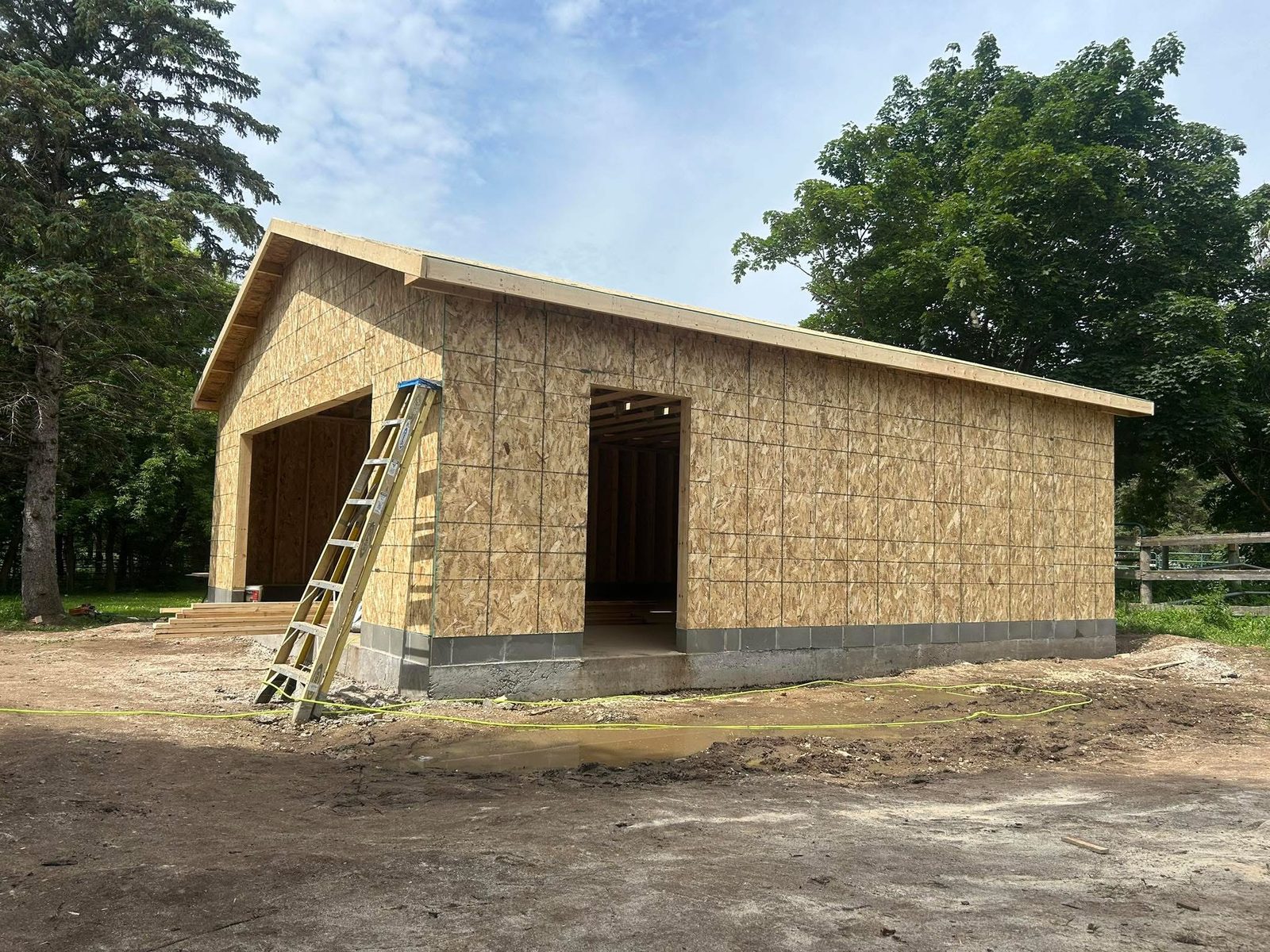 Detached garage, sheathed and roofed